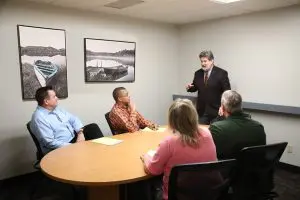 David Salter, JD talking to four clients about estate planning.