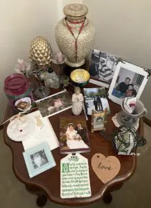 A picture of a table full of photos and keepsakes.