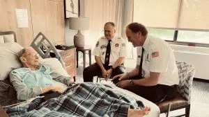VFW members visiting at the bedside of a WWII Army Colonel