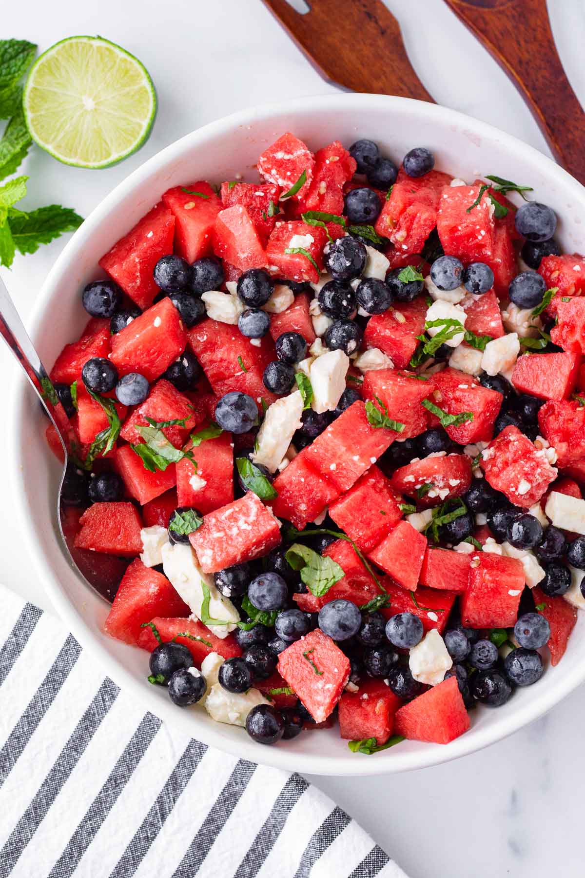 a picture of a bowl of watermelon, blueberry, feta and mint salad.